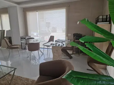 a living room with chairs and a table with a plant at CV Edifício Vitória, RC Centro - PALMAREJO BAIXO in Praia