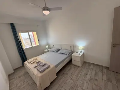 a bedroom with a bed and two night stands and a window at Apartament ROSA DEI VENTI 3D Estoril Sal Rei in Sal Rei
