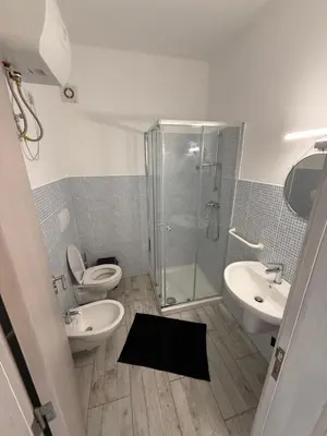 a bathroom with a shower and a toilet and a sink at Apartament ROSA DEI VENTI 3D Estoril Sal Rei in Sal Rei