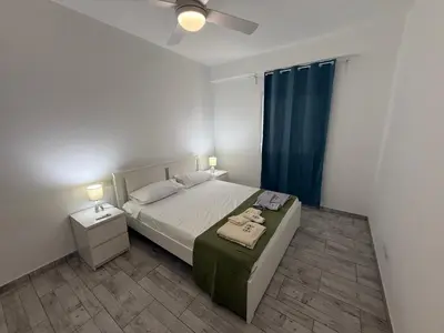 a bedroom with a bed and a ceiling fan at Apartament ROSA DEI VENTI 3D Estoril Sal Rei in Sal Rei