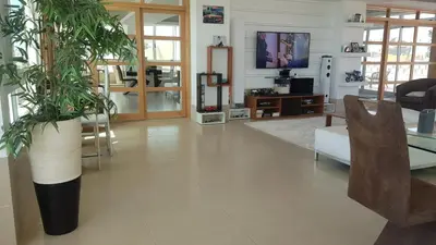 a living room with a tv and a plant at C Varela C - Casa Branca in Praia