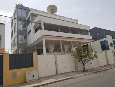 a large white building on the side of a street at C Varela C - Casa Branca in Praia