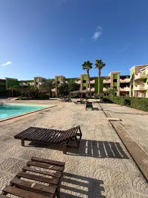 a bench next to a pool in a building at HostySpot - Bloco Verde in Santa Maria