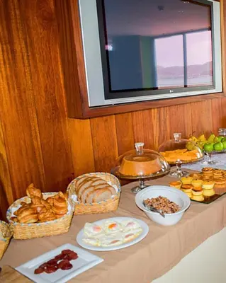 a table with bread and other food on it at Pousada do Norte, ilha do Fogo in Calheta de São Miguel