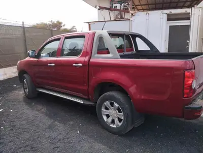a red truck parked in front of a building at Pousada do Norte, ilha do Fogo in Calheta de São Miguel