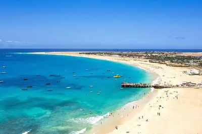 a beach with people and boats in the water at Central Santa Maria Sea view 2 Bedroomed Apartment in Santa Maria