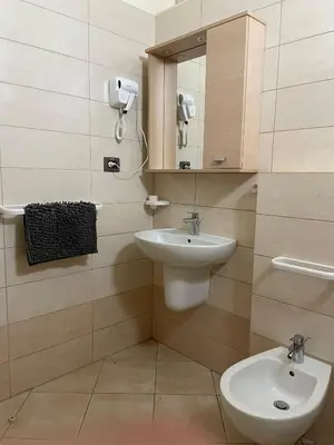 a bathroom with a sink and a mirror at Central Santa Maria Sea view 2 Bedroomed Apartment in Santa Maria