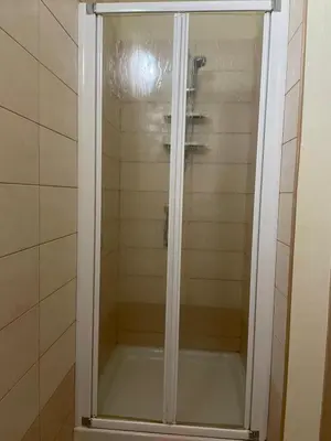 a shower with a glass door in a bathroom at Central Santa Maria Sea view 2 Bedroomed Apartment in Santa Maria
