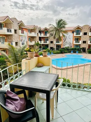 a balcony with a table and chairs and a swimming pool at Santa Maria, 4min to Beach - Pool, AC, WiFi, De'Longhi coffee maker in Santa Maria