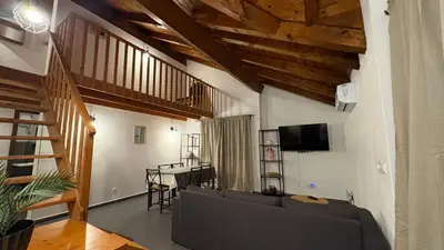 a living room with a couch and a tv at Casa Rosa Sal in Santa Maria
