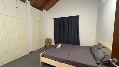 a bedroom with a bed and a black curtain at Casa Rosa Sal in Santa Maria