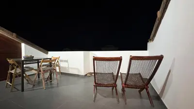a dining room with a table and two chairs and a table and chairsktop at Casa Rosa Sal in Santa Maria