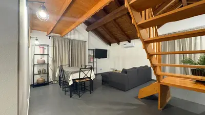 a living room with a table and a couch at Casa Rosa Sal in Santa Maria