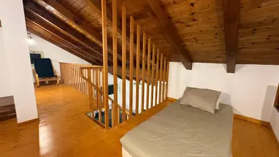 a bedroom with a bed in a room with wooden ceilings at Casa Rosa Sal in Santa Maria
