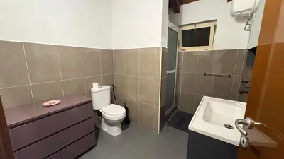 a bathroom with a toilet and a sink at Casa Rosa Sal in Santa Maria