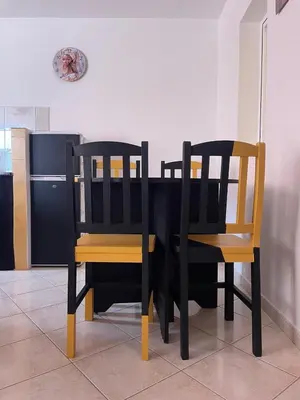 a black dining room table with two wooden chairs at Rosa dei venti 4 in Santa Maria