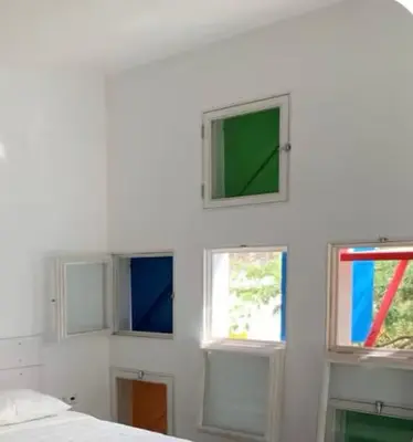a room with four windows in a white wall at Modern&Central Mindelo - 2A in Mindelo