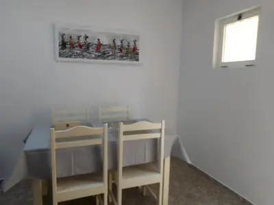 a dining room with a table and two chairs at Ca' Dolce Vita in Santa Maria