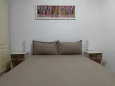 a bedroom with a bed with two end tables at Ca' Dolce Vita in Santa Maria