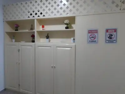 a bathroom with white cabinets and signs on the wall at Ca' Dolce Vita in Santa Maria