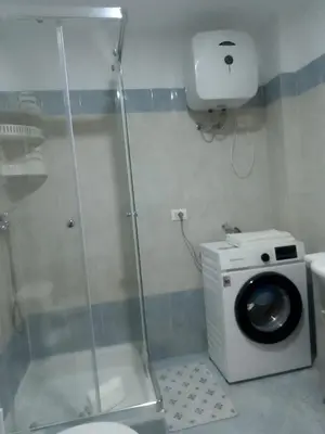 a shower in a bathroom with a washing machine at Ca' Dolce Vita in Santa Maria