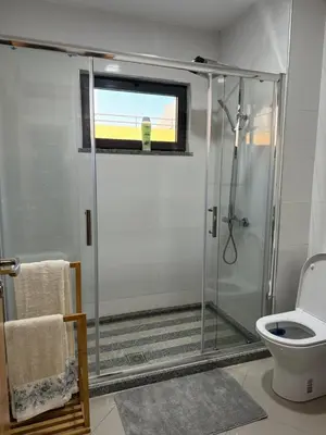 a bathroom with a shower and a toilet at Holiday AP TF 2 in Praia