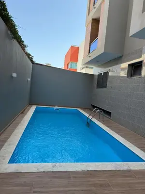 a swimming pool on the side of a building at Holiday AP TF 2 in Praia