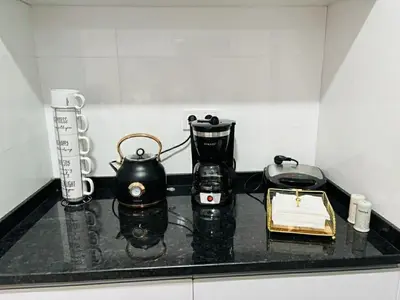 a black counter top with a tea kettle and a tea pot at Holiday AP TF 2 in Praia
