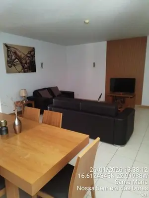 a living room with a black couch and a table at Mb HOUSE VILA VERDE RESORT in Prainha