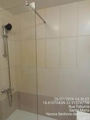 a shower with a glass door in a bathroom at Mb HOUSE VILA VERDE RESORT in Prainha