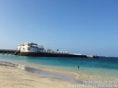 a person swimming in the ocean next to a pier at Mb HOUSE VILA VERDE RESORT in Prainha