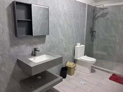 a bathroom with a sink and a toilet and a mirror at Apartment T3 located Rua 4 de Julho Sal Rei blv in Sal Rei