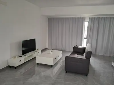 a living room with a couch and a tv at Apartment T3 located Rua 4 de Julho Sal Rei blv in Sal Rei