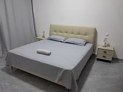 a bedroom with a large bed with two night stands at Apartment T3 located Rua 4 de Julho Sal Rei blv in Sal Rei