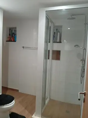 a bathroom with a shower and a toilet at Praia Sunset Horizon Apartment