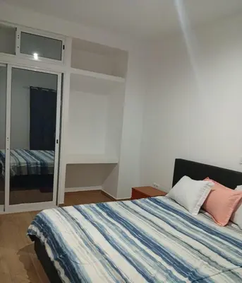 a bedroom with a bed and a mirror at Praia Sunset Horizon Apartment