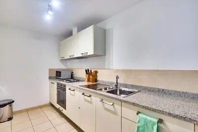 a kitchen with white cabinets and a sink at T2 Santa Maria, Ilha do Sal, Cabo Verde - Melia Tortuga Beach Resort in Prainha