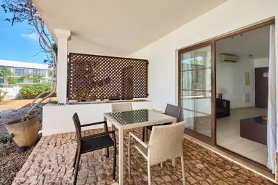 a dining room with a table and chairs on a patio at T2 Santa Maria, Ilha do Sal, Cabo Verde - Melia Tortuga Beach Resort in Prainha