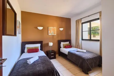 a bedroom with two beds and a window at T2 Santa Maria, Ilha do Sal, Cabo Verde - Melia Tortuga Beach Resort in Prainha