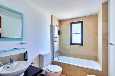 a bathroom with a tub and a sink and a toilet at T2 Santa Maria, Ilha do Sal, Cabo Verde - Melia Tortuga Beach Resort in Prainha