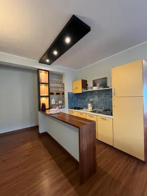 a large kitchen with a counter and a refrigerator at WIND Ocean View Lobster Dinner Included in Santa Maria
