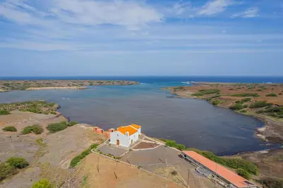 an aerial view of a house on a island in the water at Hospedaria Santo António
