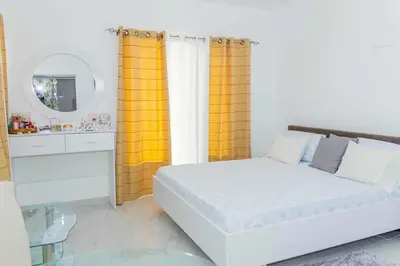 a bedroom with a white bed and a mirror at Hospedaria Santo António
