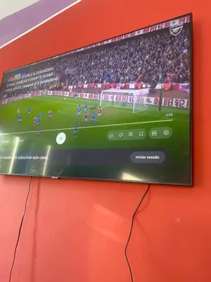 a flat screen tv on a wall with a soccer game at Campo do campo ocean view in São Filipe