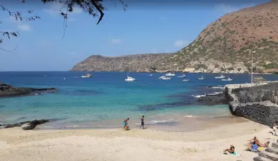 a group of people on a beach with boats in the water at Prainha Beach Home in Praia