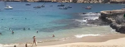 a group of people in the water at a beach at Prainha Beach Home in Praia