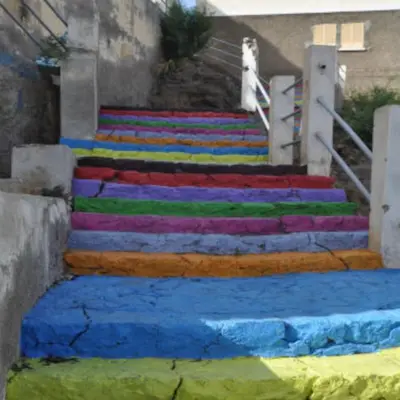a set ofcolored steps with rainbow paint on them at Prainha Beach Home in Praia