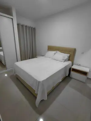 a white bed in a white room with a bed sidx sidx sidx at C&C Guesthouse in Praia