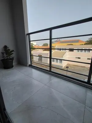 a room with a large window with a view of a building at C&C Guesthouse in Praia