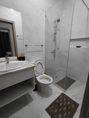 a bathroom with a shower and a toilet and a sink at C&C Guesthouse in Praia